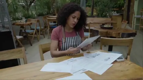 A business owner reviewing paperwork at a table