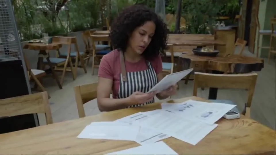 A business owner reviewing paperwork at a table